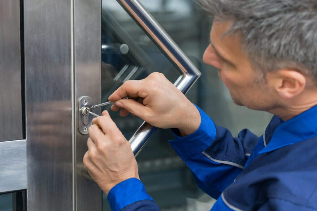 A locksmith working on a door lock