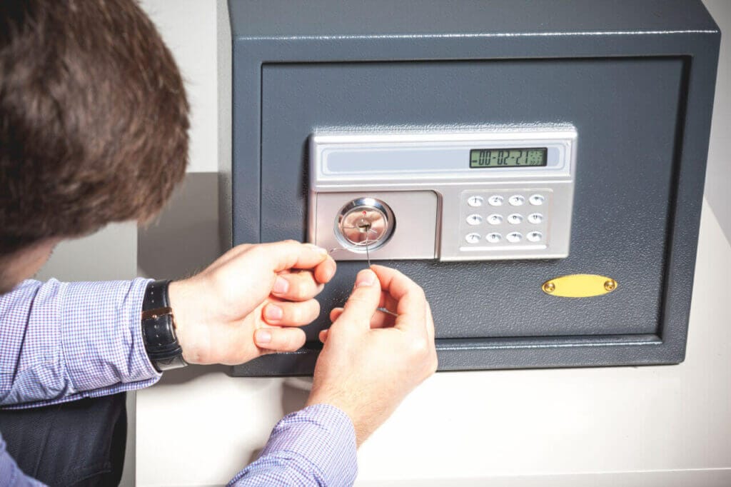 A locksmith working on a safe lock