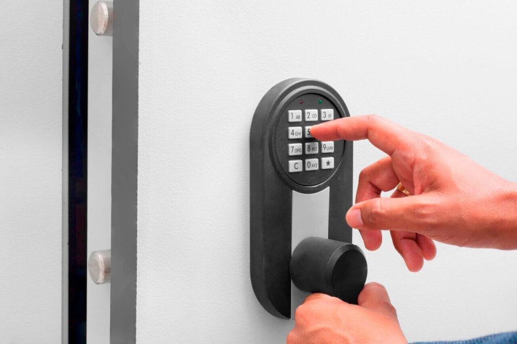 A Person Inputting The Code Into The Keypad Of A Keyless Door Lock