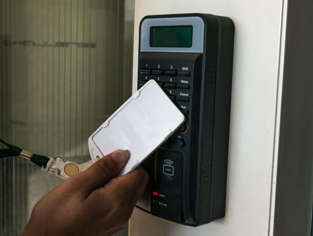 A person opening a keyless door lock through card