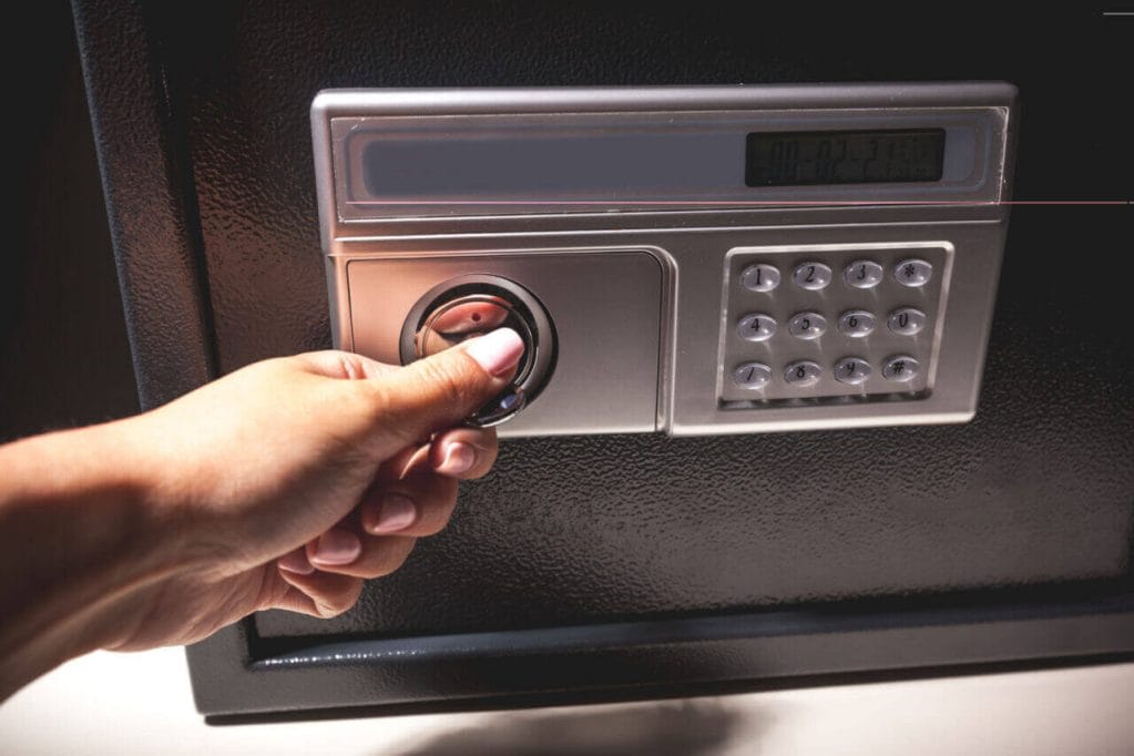 A Person Opening The Lock Of A Safe