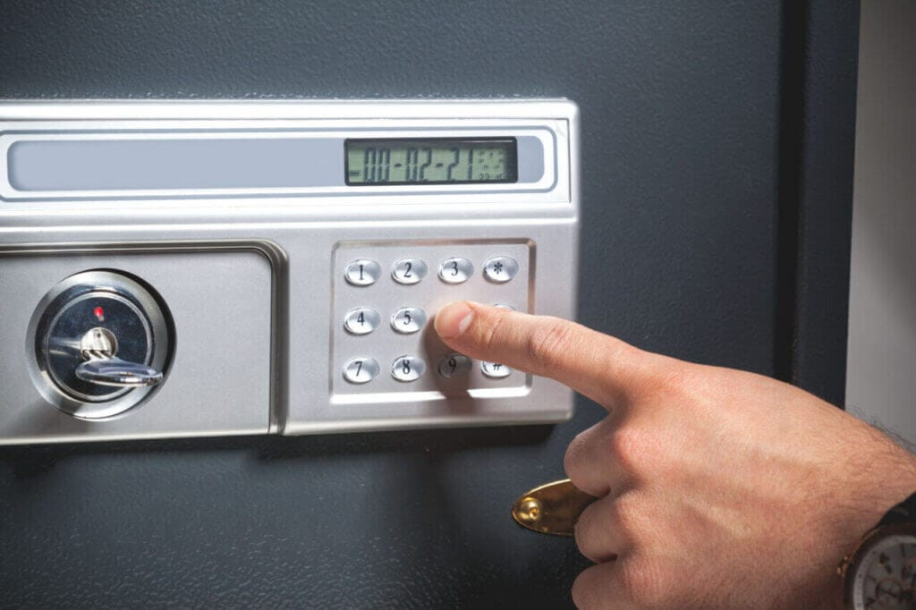 Close up of a hand inputting code into an electronic safe lock