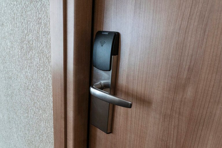 Close up of an electronic door lock with black handle
