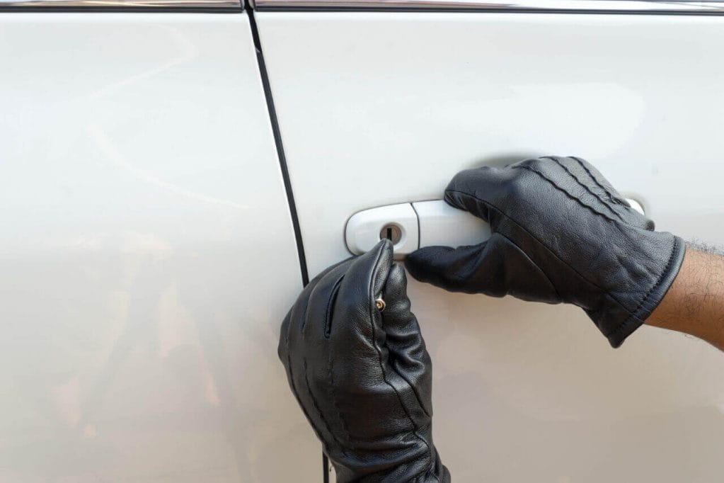 Close Up Of Locksmiths Hands Opening A Car Door Lock