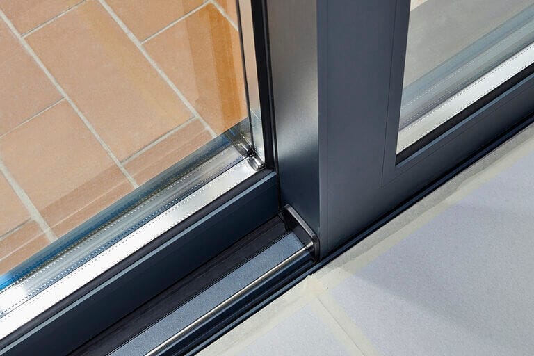 Close up of the bottom track of a sliding door
