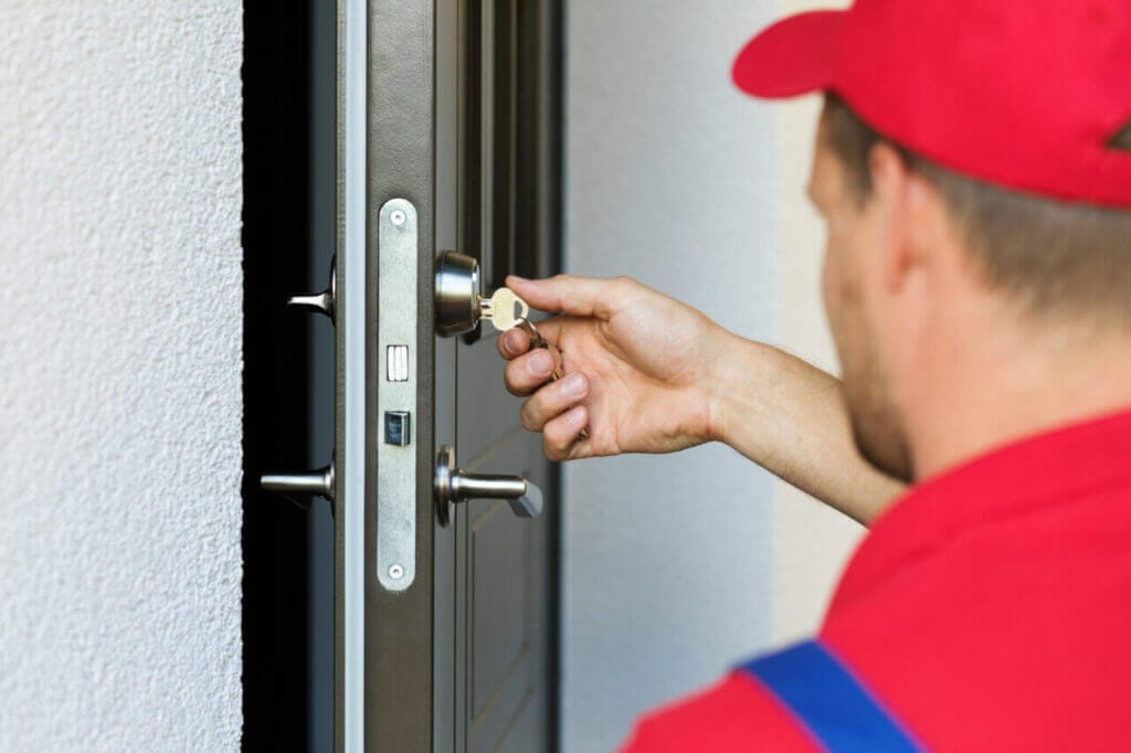 Locksmith Inserting A Key Into A Door Lock