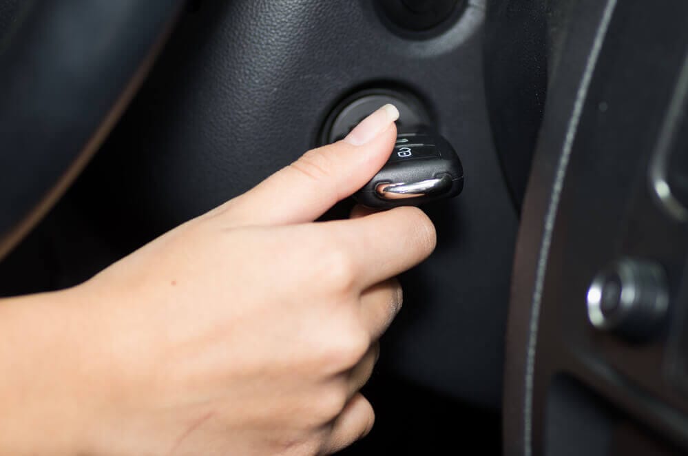 A Hand Inserting A Key In Car Ignition
