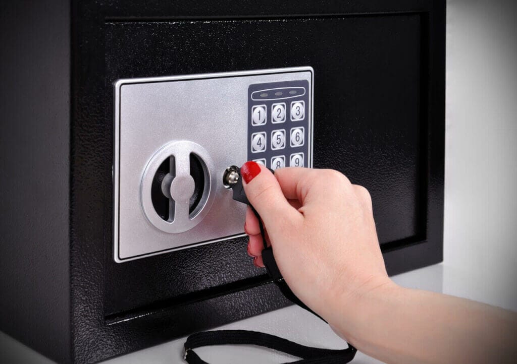 Hand Attempting To Open The Safe With A Key